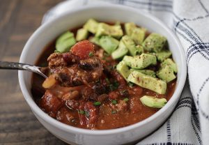 Pumpkin Chipotle Chili in Bowl with Diced Avocado