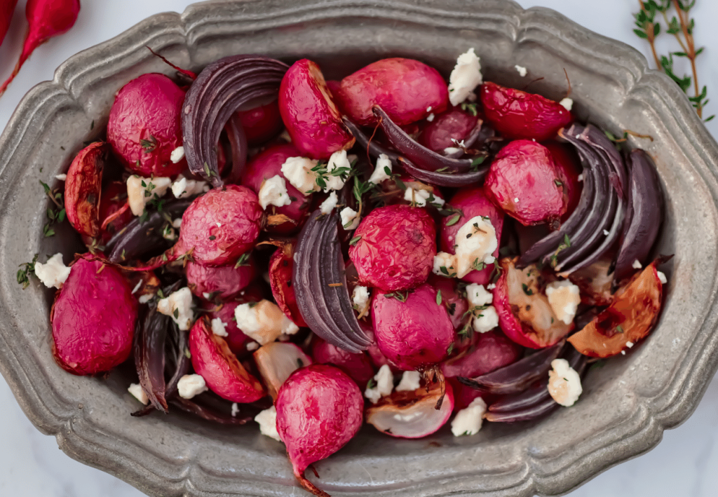 Bright pink roasted radishes with purple onion and goat cheese